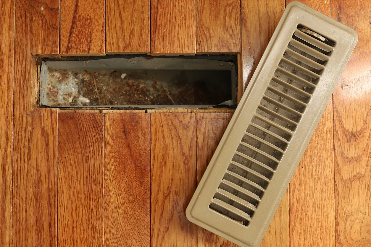 A brown air vent featuring a central hole